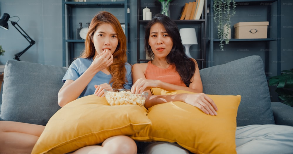 Attractive Asia lovely couple lady positive glad cheerful with casual have fun and enjoy moment watch online movie entertainment on couch in living room at home.