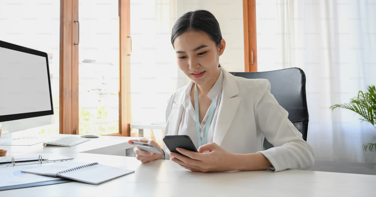 A beautiful female manager or business worker using smartphone to pay a ...