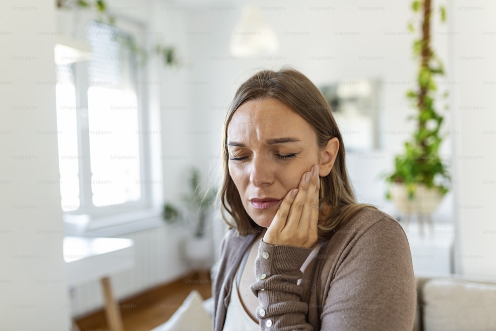 Tooth Pain And Dentistry. Young Woman Suffering From Terrible Strong Teeth Pain, Touching Cheek With Hand. Female Feeling Painful Toothache. Dental Care And Health Concept.