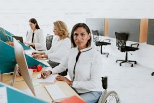 transgender latin woman working with computer at the office in Mexico Latin America