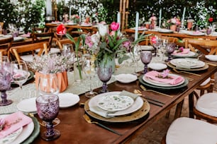 table setup with flowers, glasses and plates on table decorated for Wedding Reception in terrace Latin America