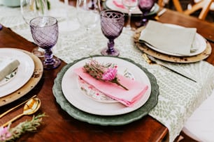 table setup with flowers, glasses and plates on table decorated for Wedding Reception in terrace Latin America