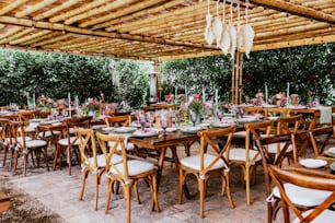 terrace with tables setup with flowers and plates on table decorated for Wedding Reception in Latin America