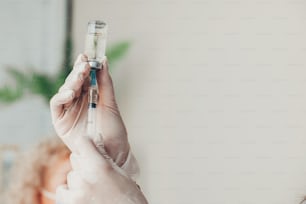 Doctor's hands holding a syringe with Coronavirus vaccine. Covid-19 Vaccination. Medical treatment. Virus protection.