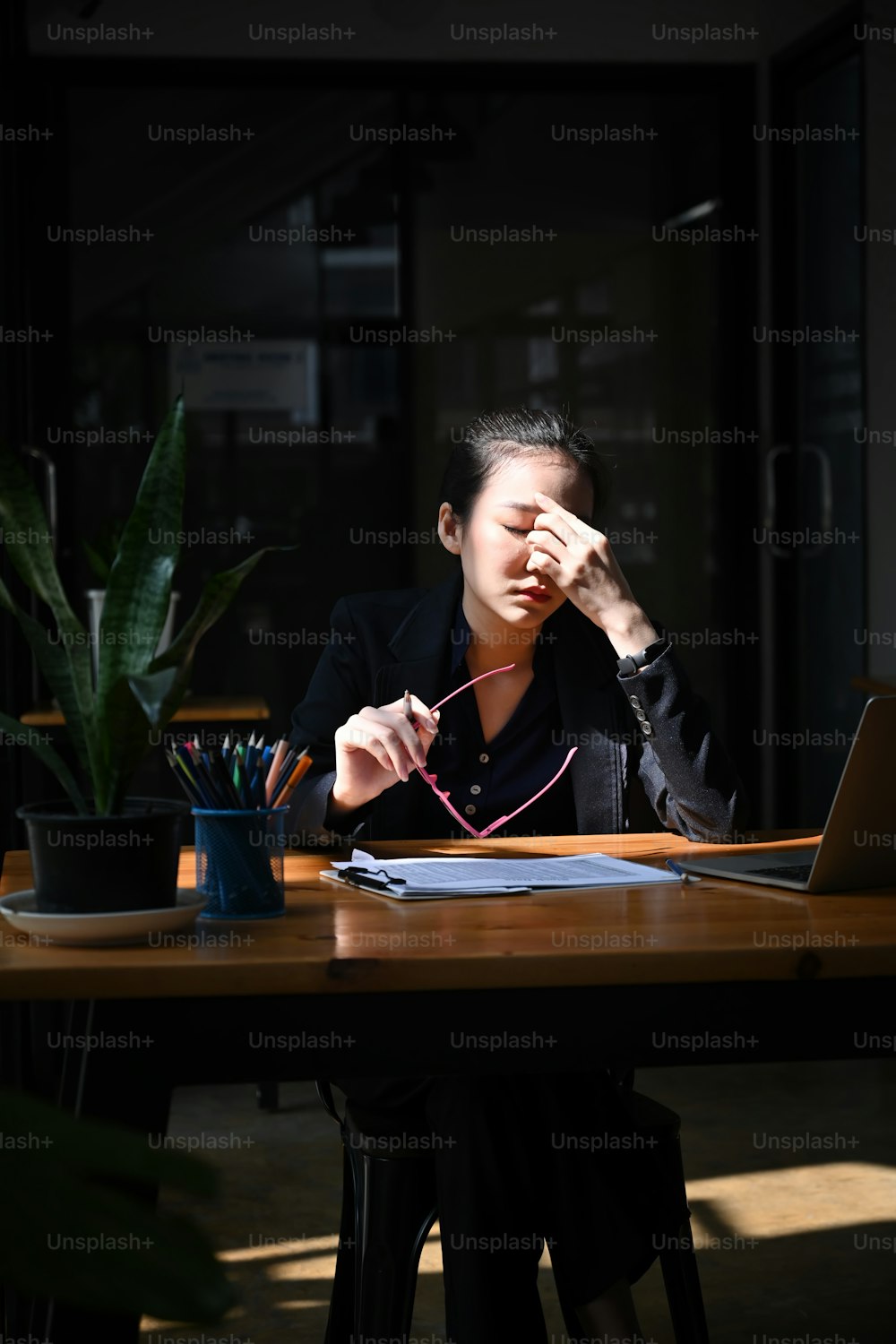 Tired businesswoman take off glasses and massaging nose bridge.