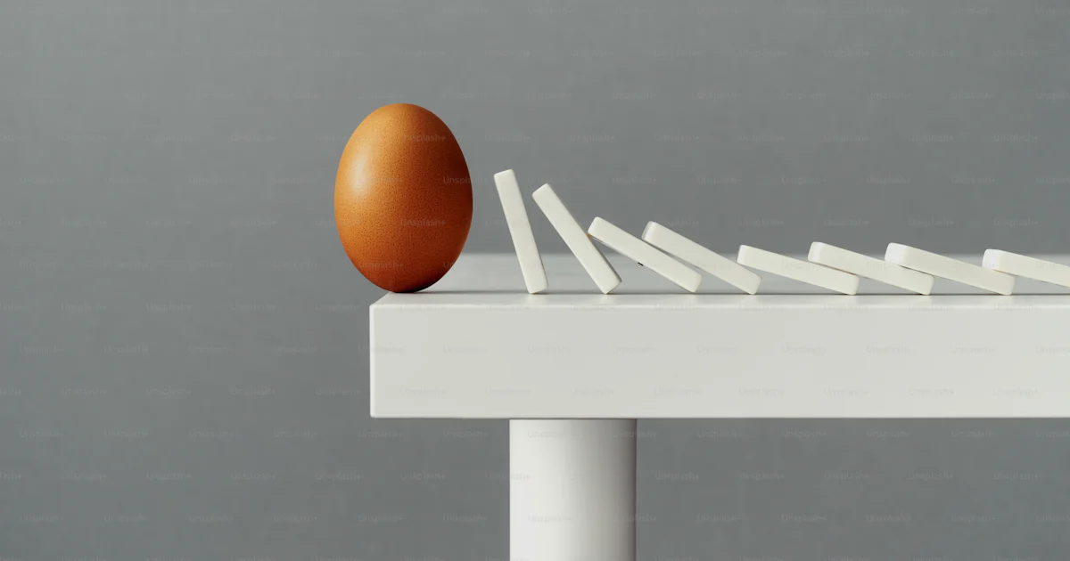 Table Fall Down Egg balancing on the edge of a table, about to fall down and break due ...