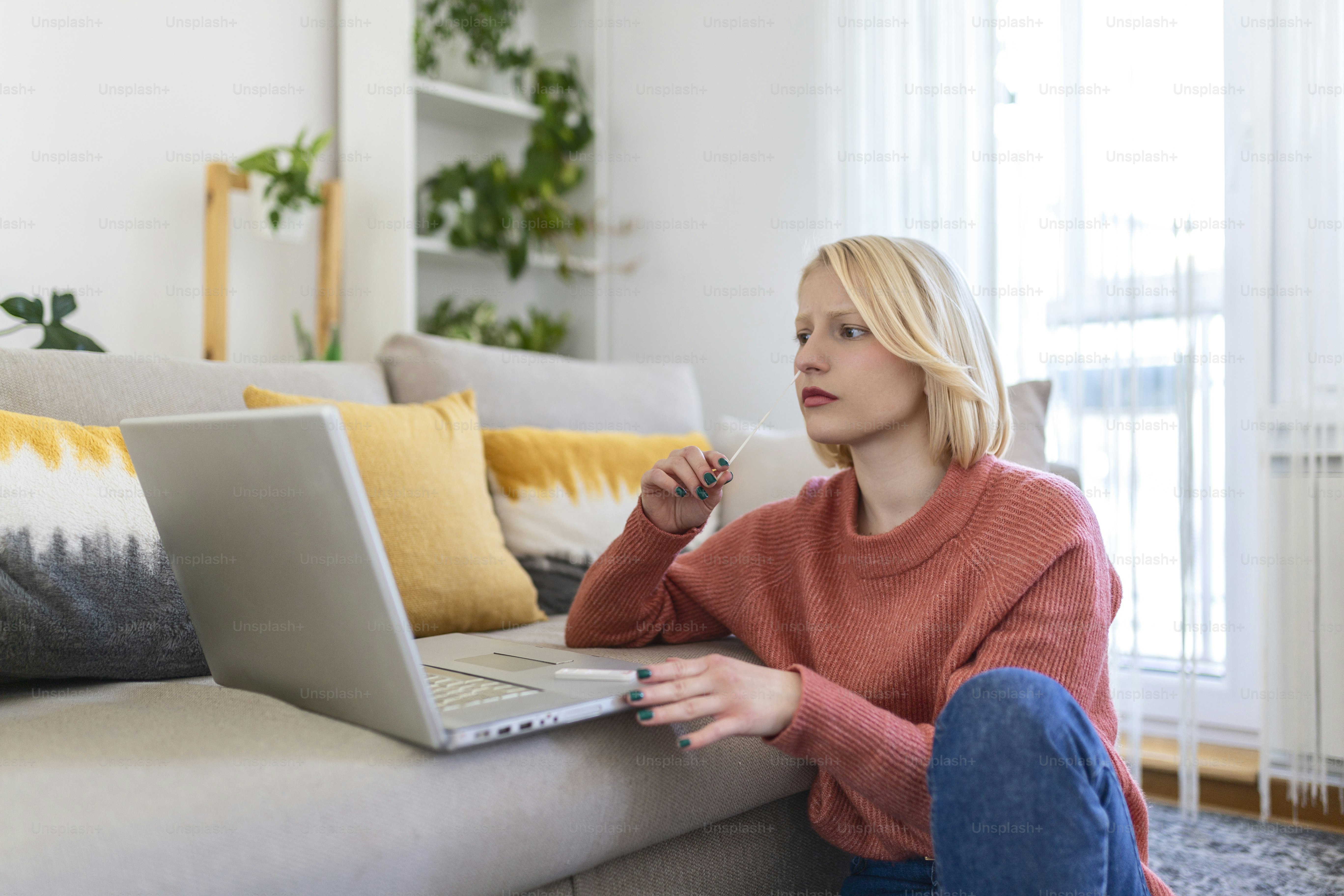 Woman self test for COVID-19 home test kit. Coronavirus nasal swab test for infection. Telemedicine and Telehealth distribution of health-related services online. Internet doctor in video call