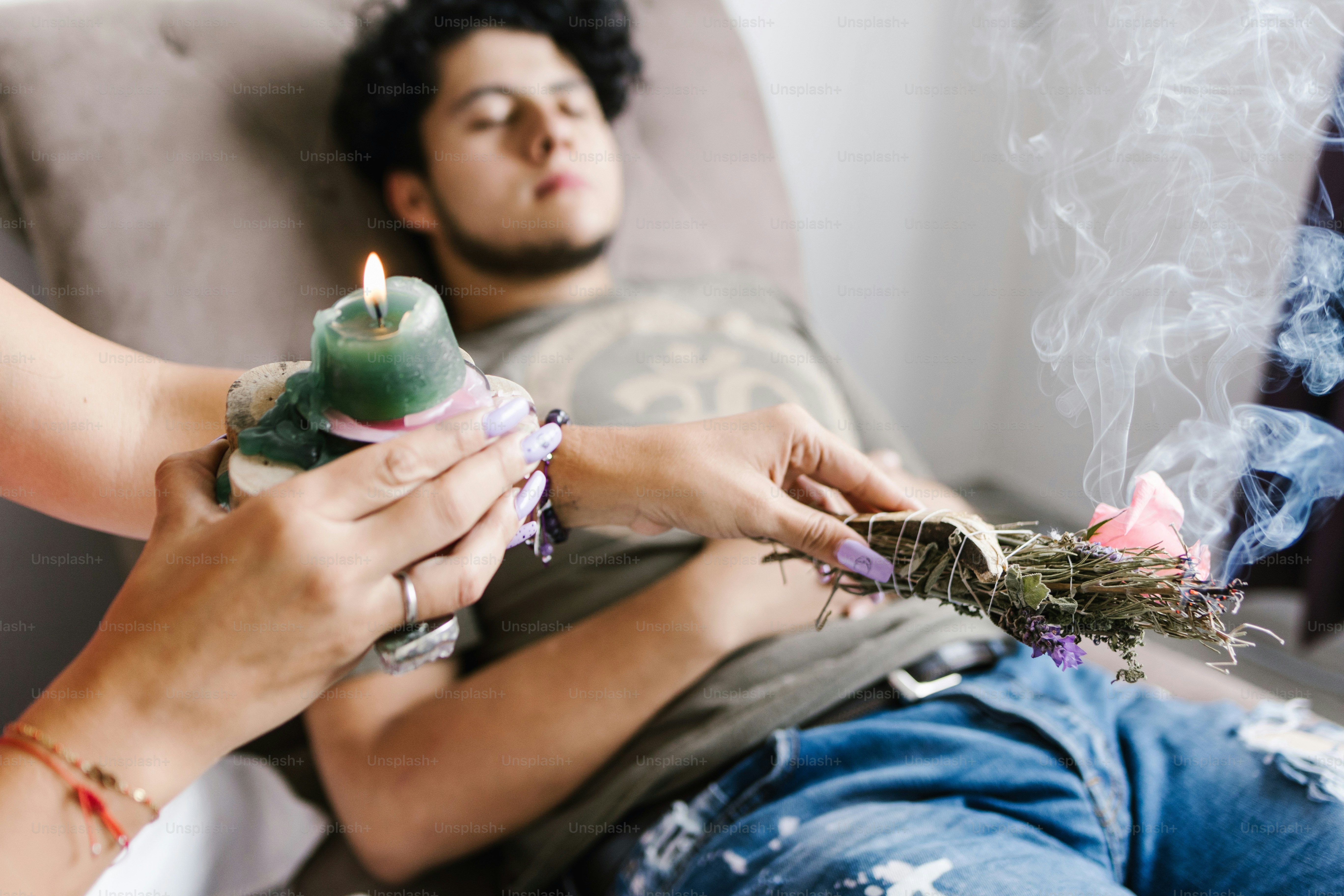 Young mexican male in healing session lying on the divan in holistic ...