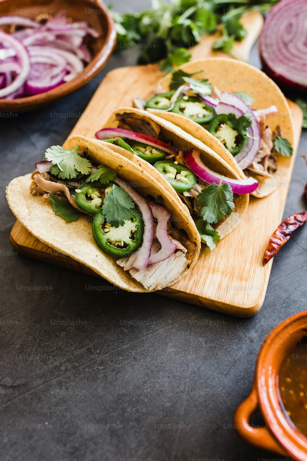 mexican street tacos ingredients with pork carnitas, tortillas, avocado, onion, cilantro in Mexico city