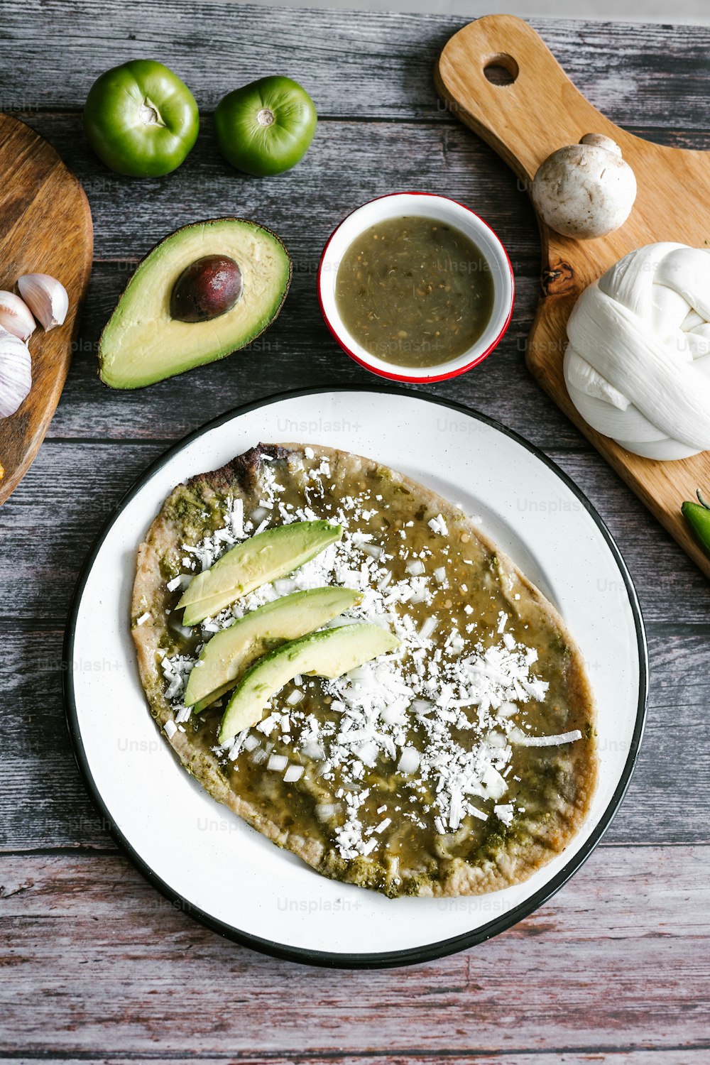 Memela sope quesadilla poblana of green sauce with cheese, onion and avocado traditional Mexican food from Puebla, Mexico