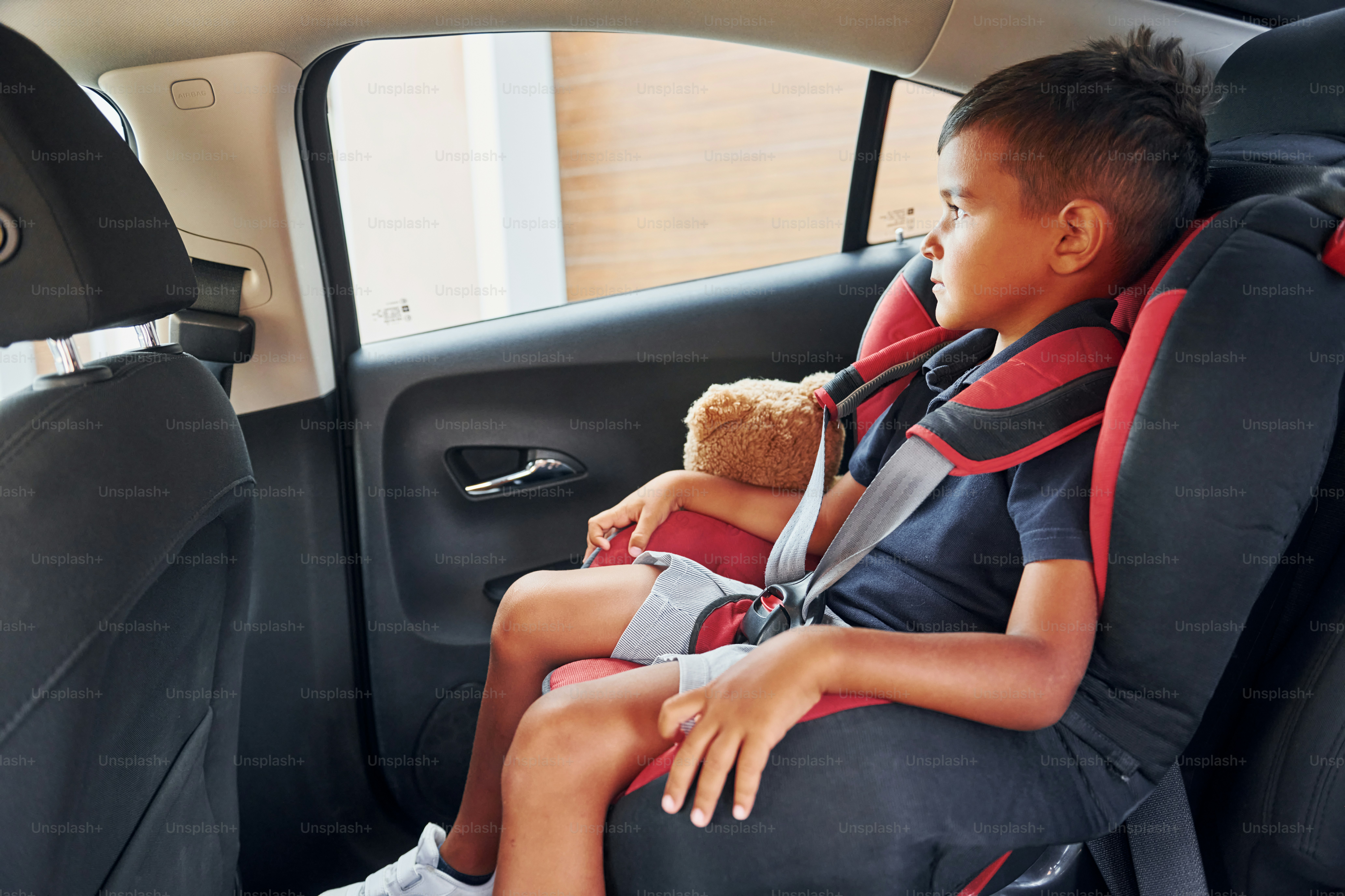 Little boy with teddy bear is sitting in the automobile. photo – Riding ...