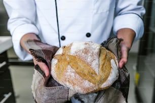 baker hands holding piece of bread at kitchen in Mexico Latin America