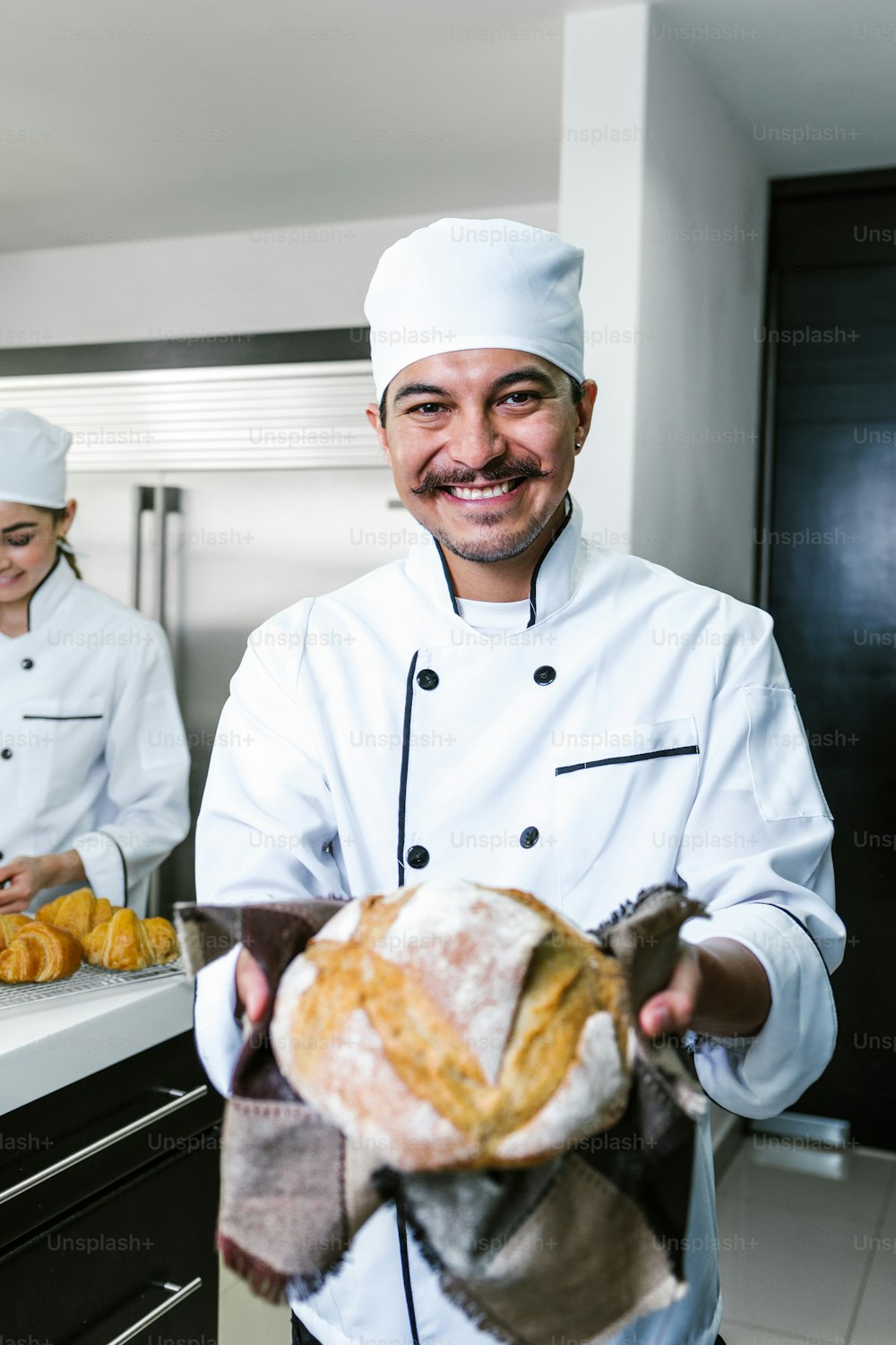 young Latin man baker and baking bread on oven at kitchen in Mexico Latin America