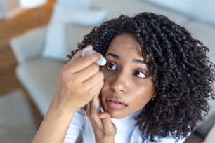 Woman using eye drop, woman dropping eye lubricant to treat dry eye or allergy, sick woman treating eyeball irritation or inflammation woman suffering from irritated eye, optical symptoms