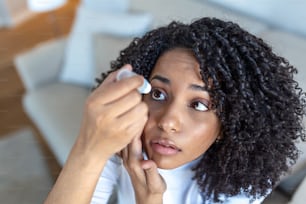 点眼薬を使用している女性、ドライアイやアレルギーを治療するために眼球の潤滑剤を滴下している女性、眼球の炎症や炎症を治療している病気の女性、刺激された目、光学症状に苦しんでいる女性