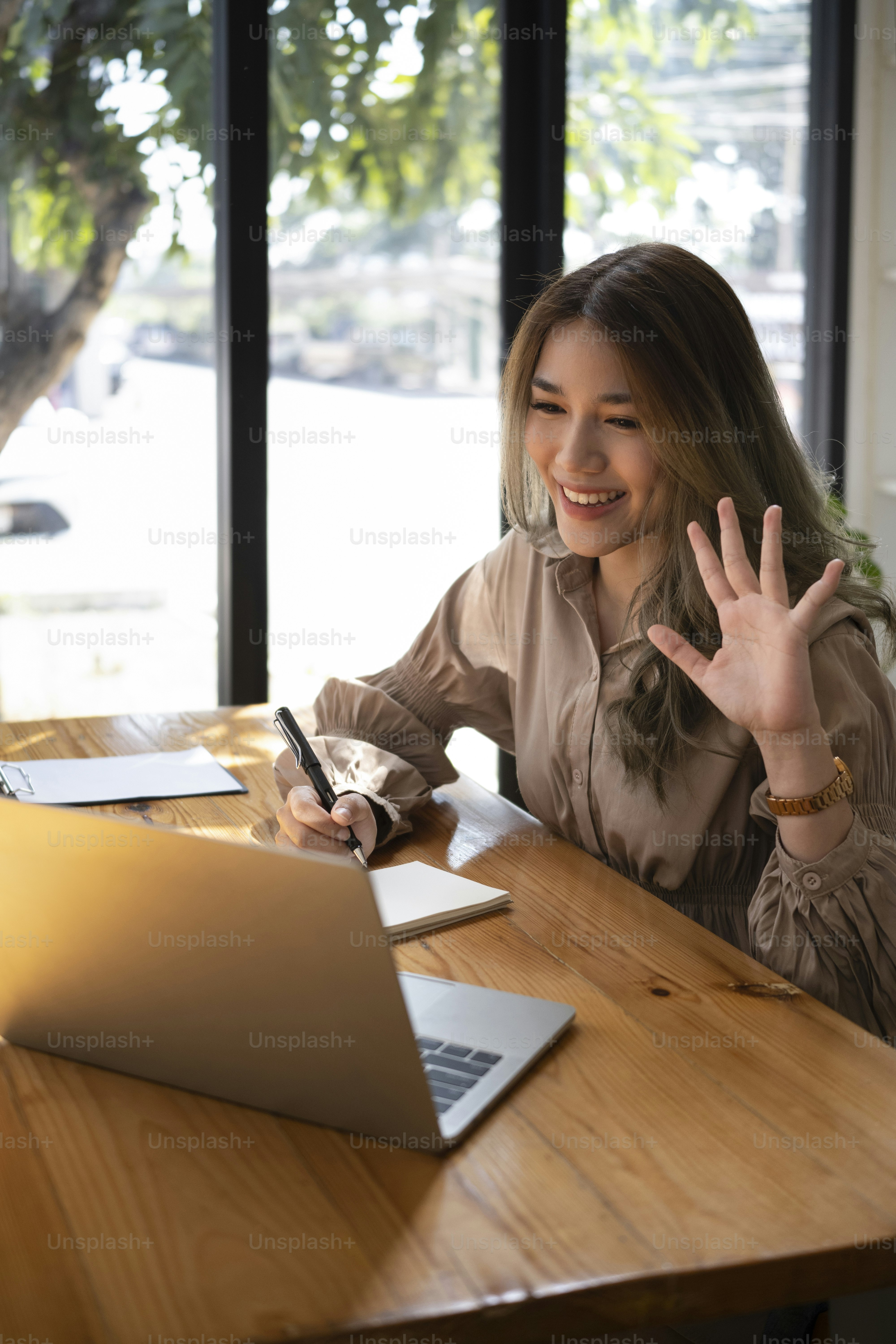 Beautiful asian woman having video conference on laptop computer.