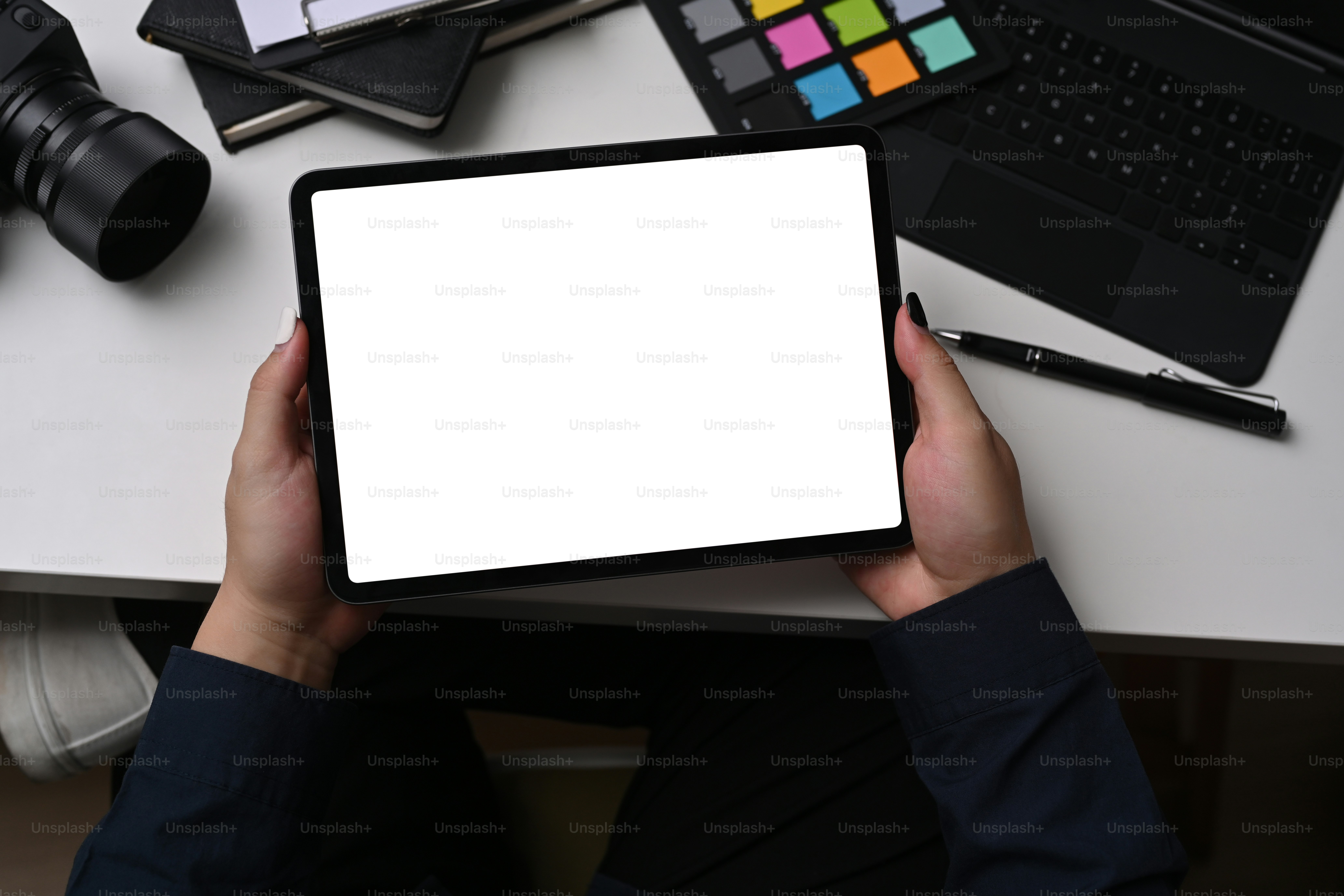 Graphiste utilisant une tablette numérique tout en étant assis sur un lieu de travail créatif.