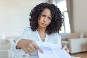 Cropped view of female lawyer giving document and pen, while sitting at workplace with themis figurine on blurred background