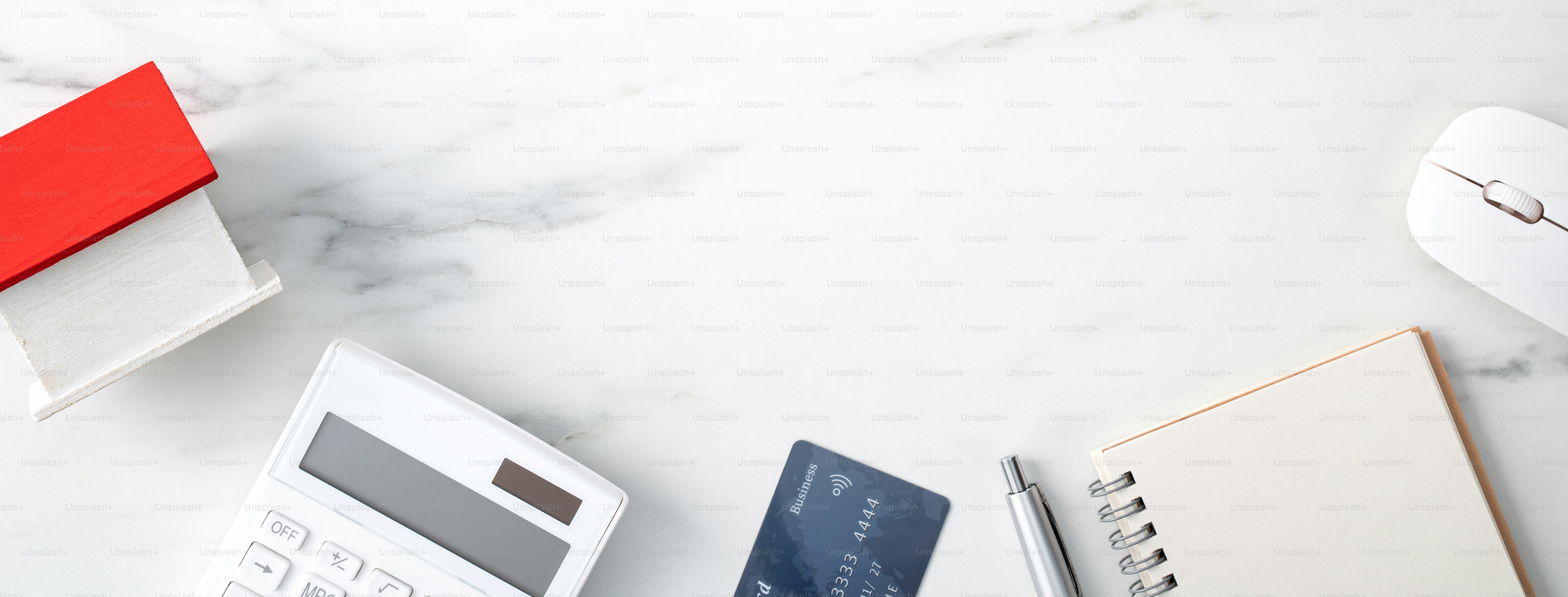 Draufsicht auf die Schätzung und Zahlung der Haussteuer mit Taschenrechner und Kreditkarte aus dem Internet.