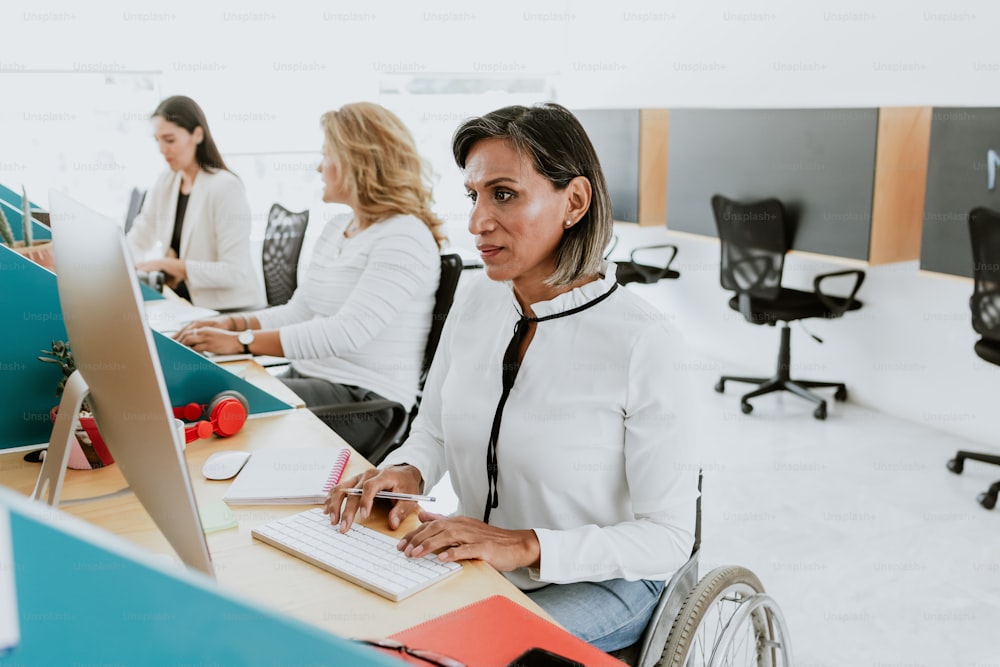 transgender latin woman working with computer at the office in Mexico Latin America