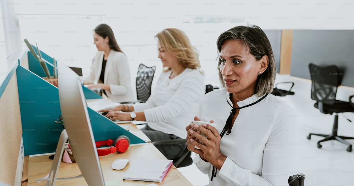 Transgender latin woman working with computer at the office in Mexico ...