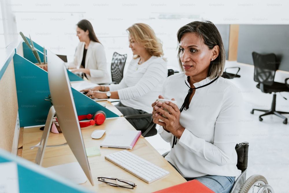 transgender latin woman working with computer at the office in Mexico Latin America