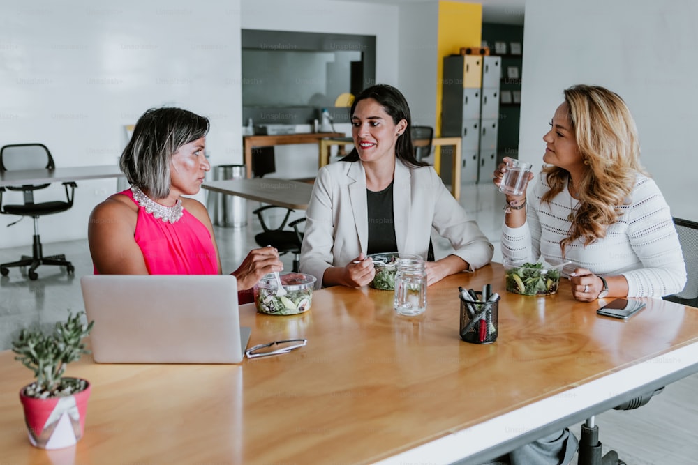 latin business women middle age, talking and advising each other at the office in Mexico Latin America