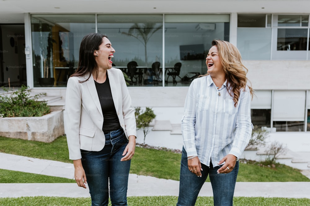 two latin women friends having fun at terrace office in Mexico Latin America