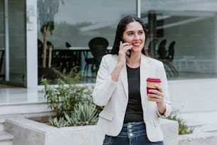 latin business adult woman calling by mobile phone at the office terrace in Mexico Latin America