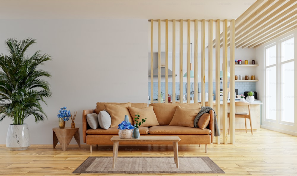 Maqueta de pared interior de la sala de estar en tonos cálidos con sofá de cuero que está detrás de la cocina renderizado .3d