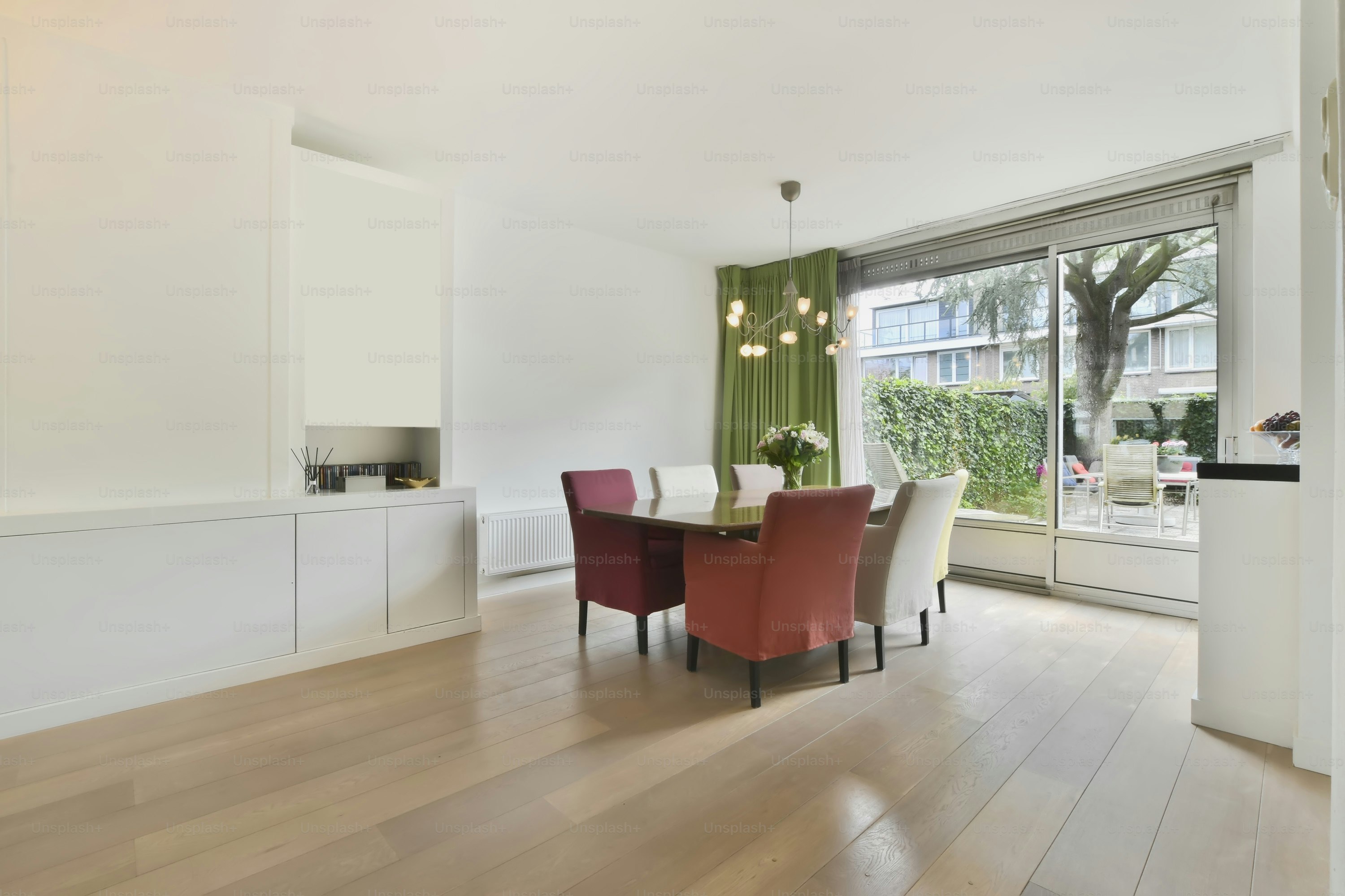 Dining area with a large table, bright chairs and bright design