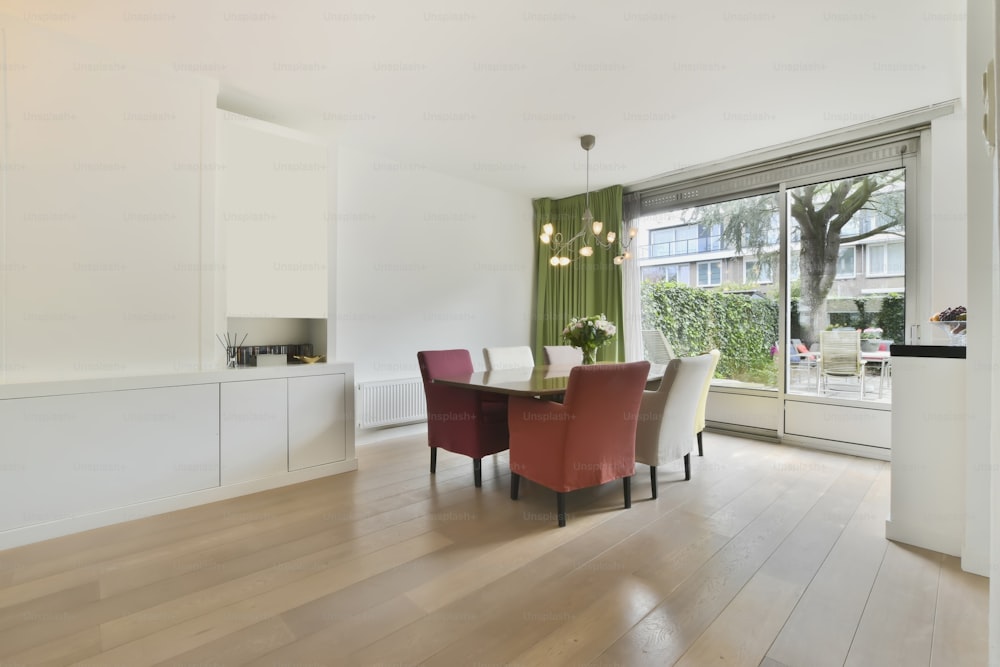 Dining area with a large table, bright chairs and bright design