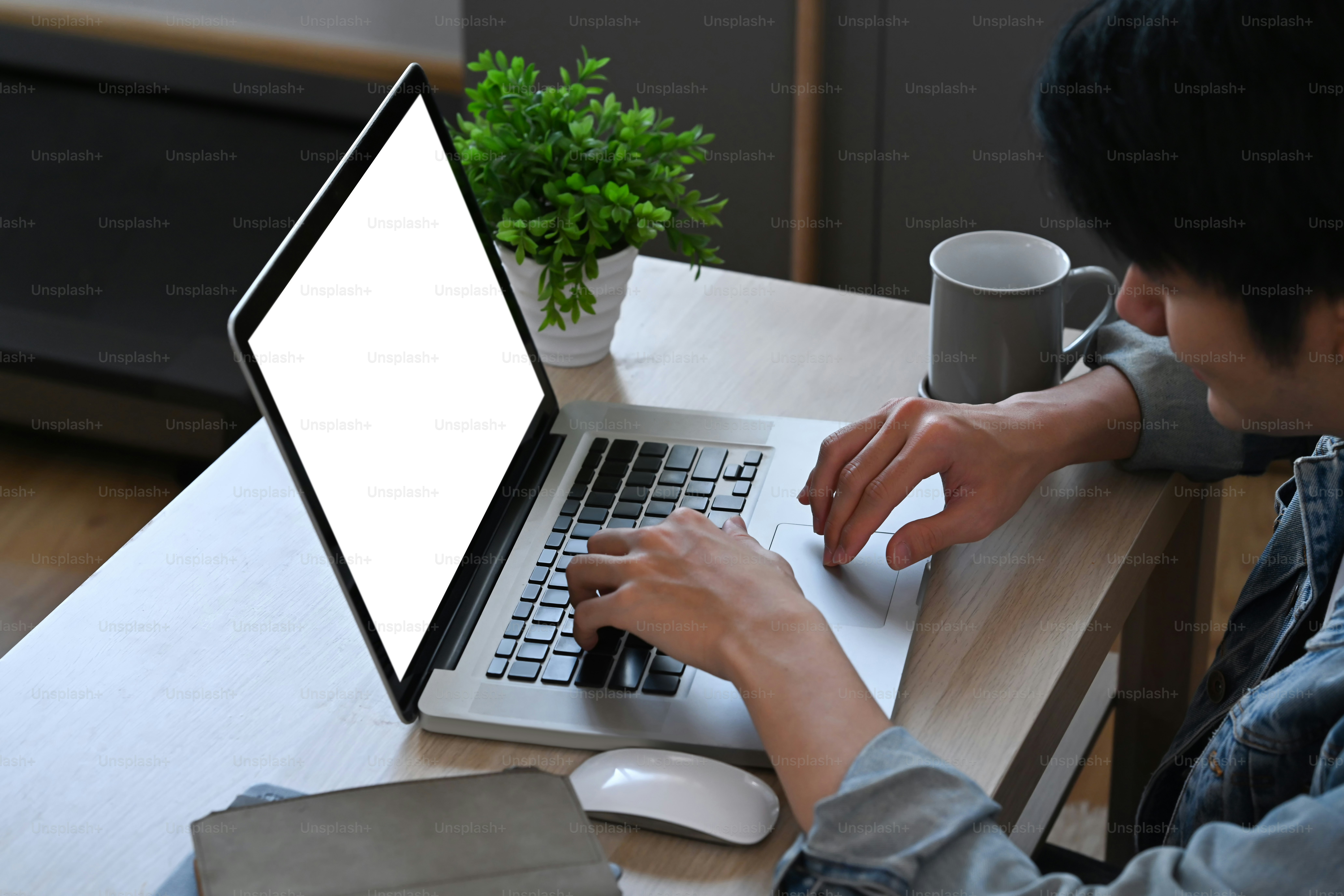 Asian man using internet banking service, searching information on laptop computer at home.