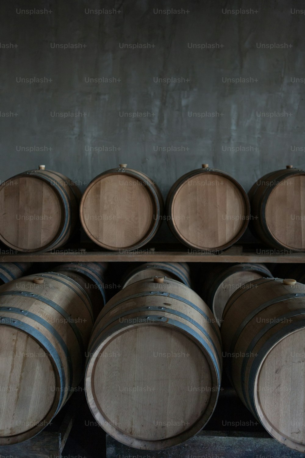 Wine barrels stacked in the cellar of the wineryWine barrels stacked in the cellar of the winery