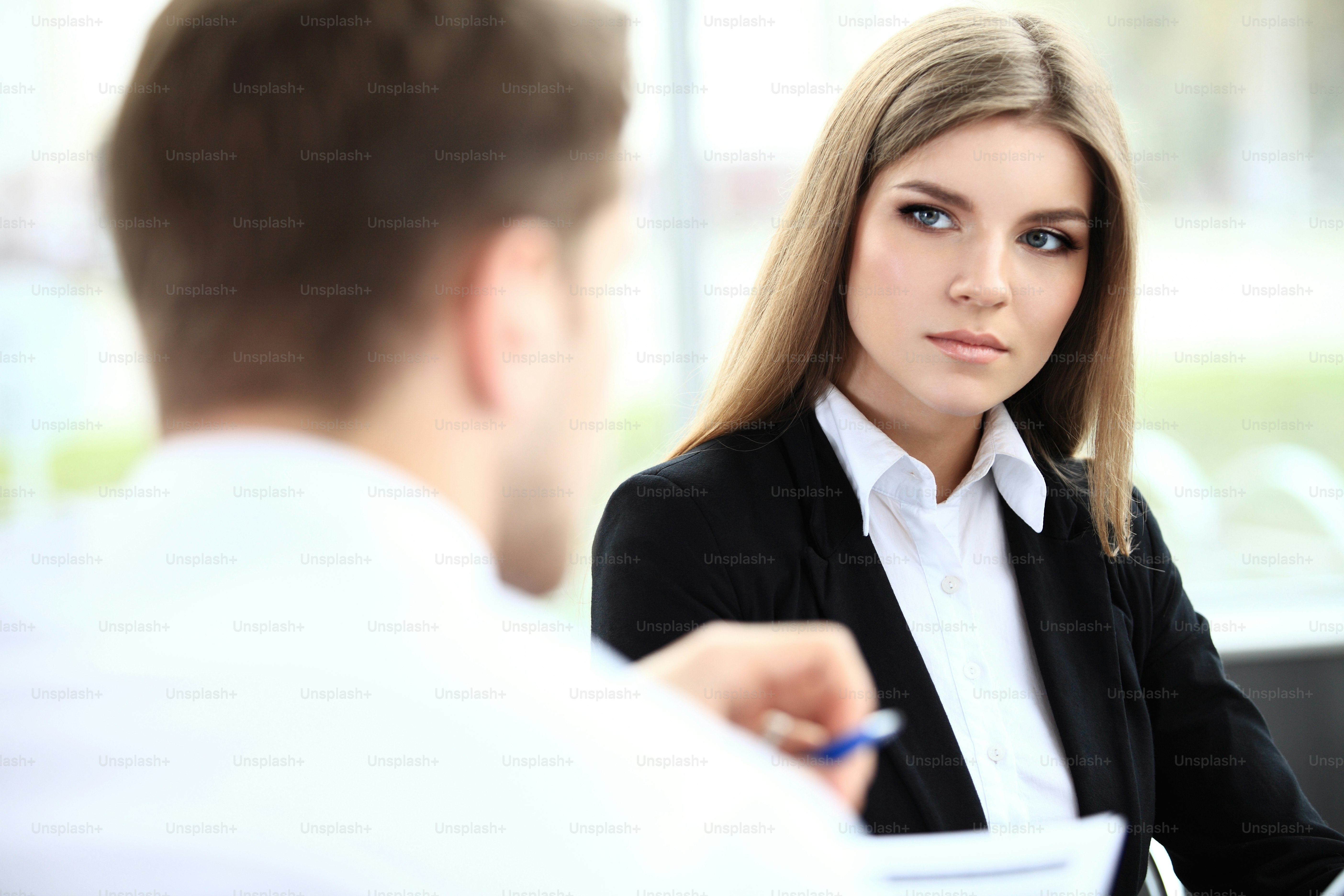 Face of beautiful woman on the background of business people