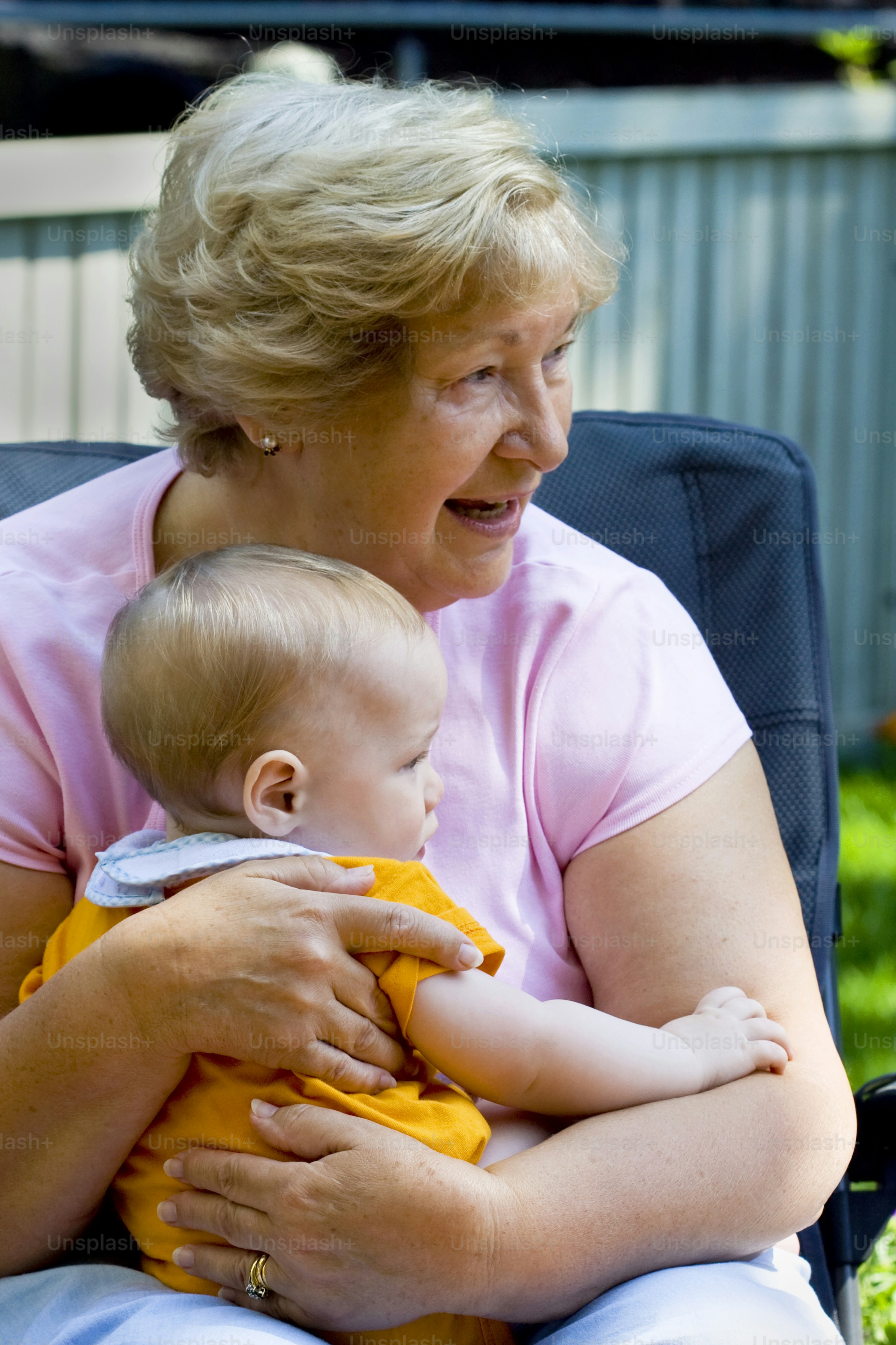 a woman sitting in a chair holding a baby