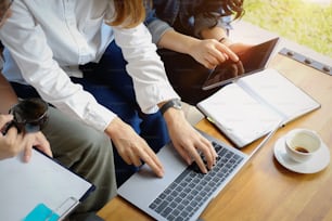 Shot of a group of coworkers discussing something on a laptop during a meeting