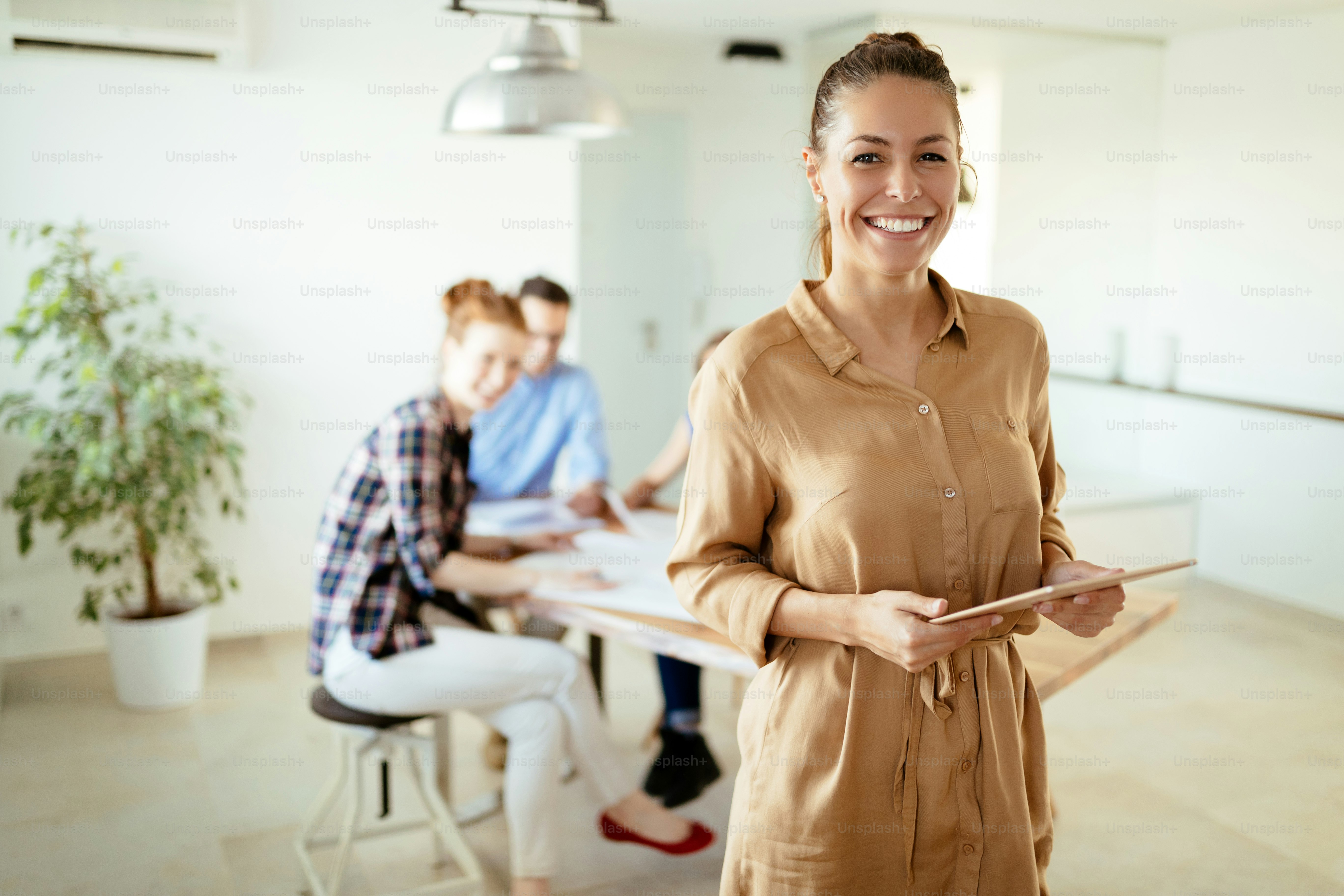 Image of young business woman looking at tablet