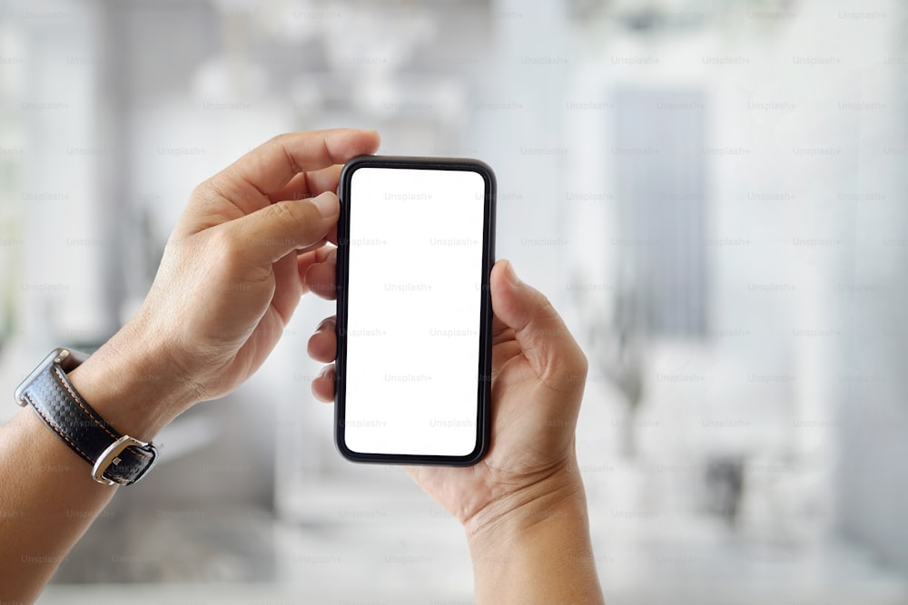 Closeup shot of an unidentifiable man using a smartphone and blurred background.