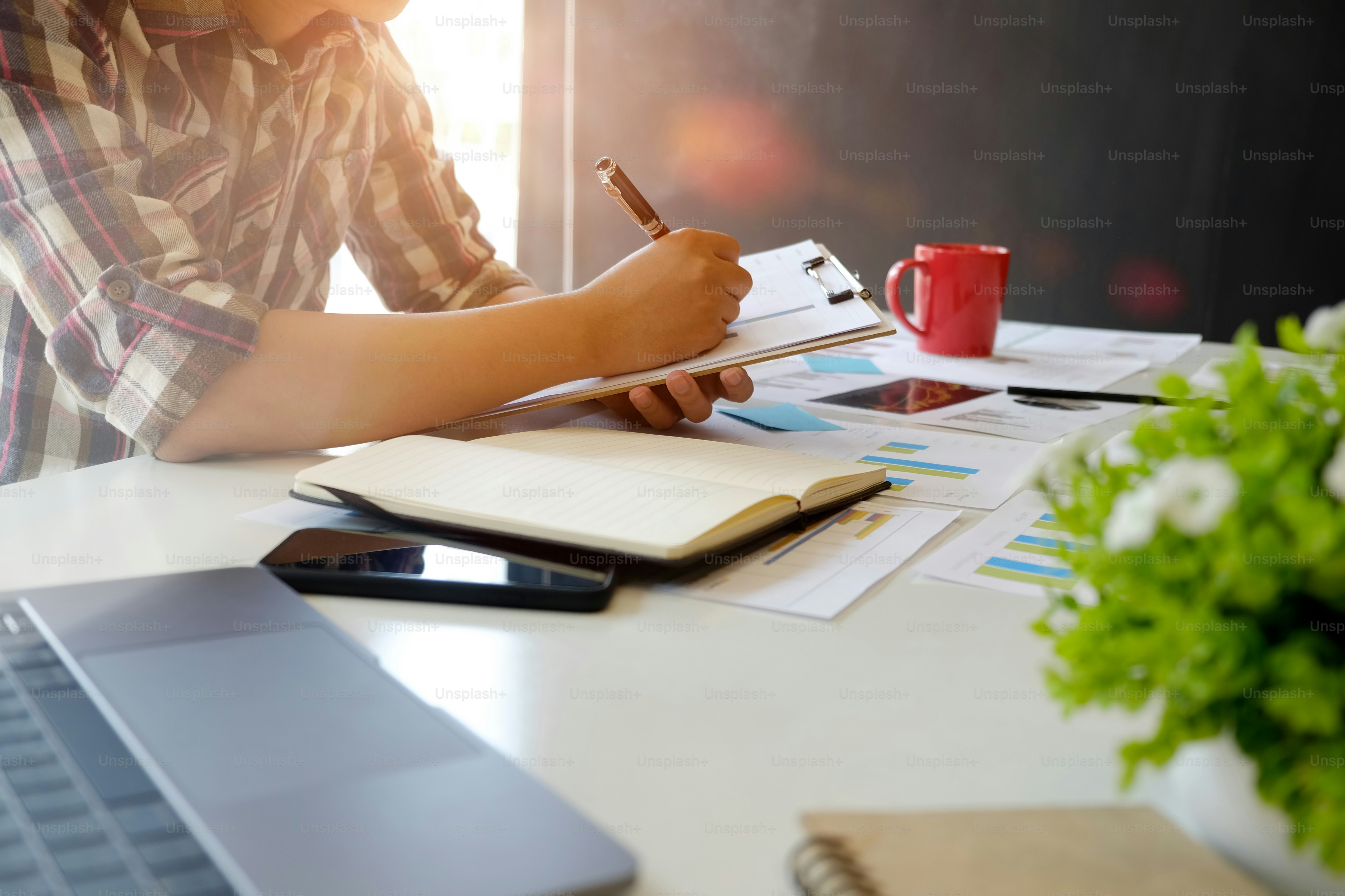 Cropped shot of man working with document at office.