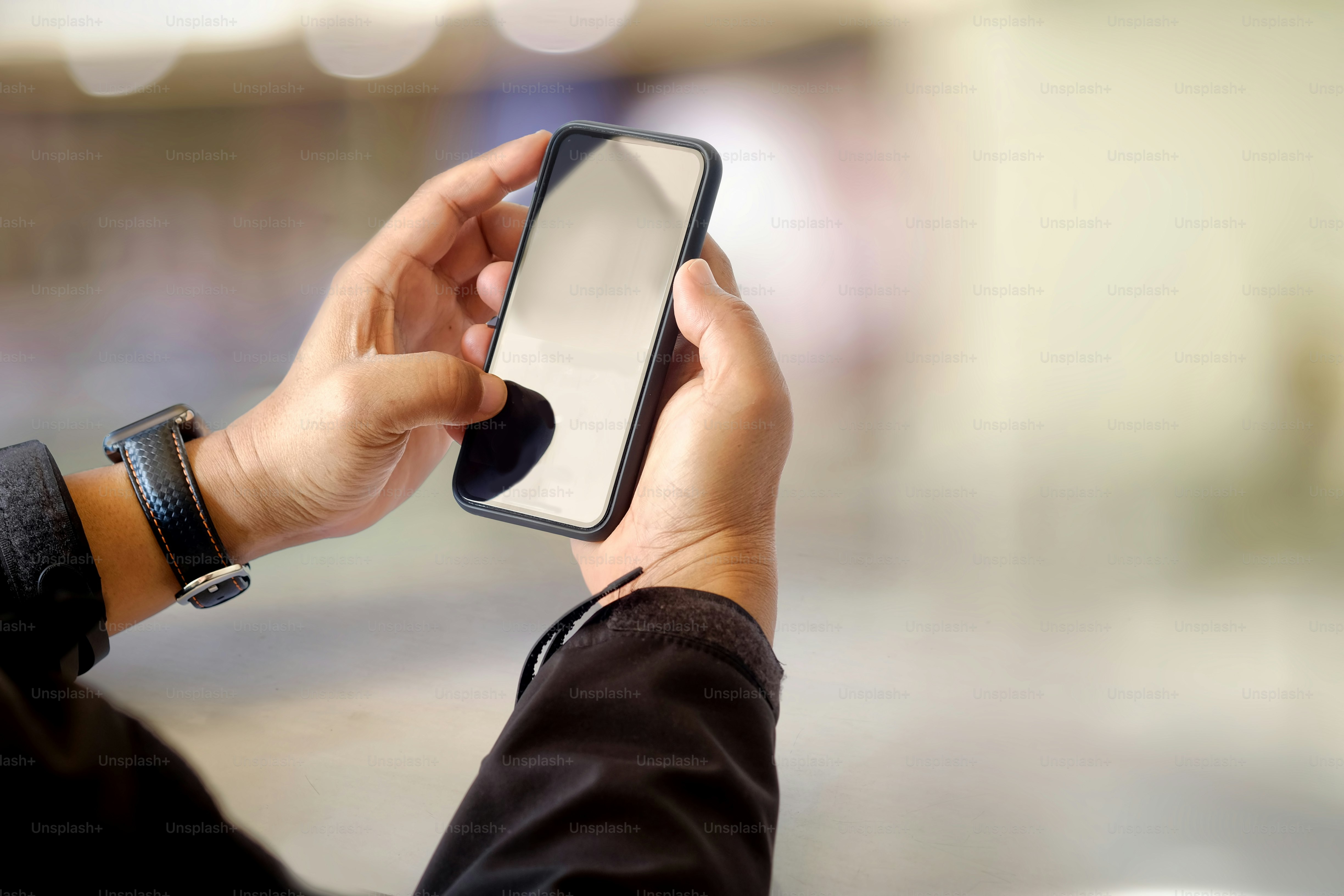 Closeup shot of an unidentifiable woman using a smartphone over blurred background.
