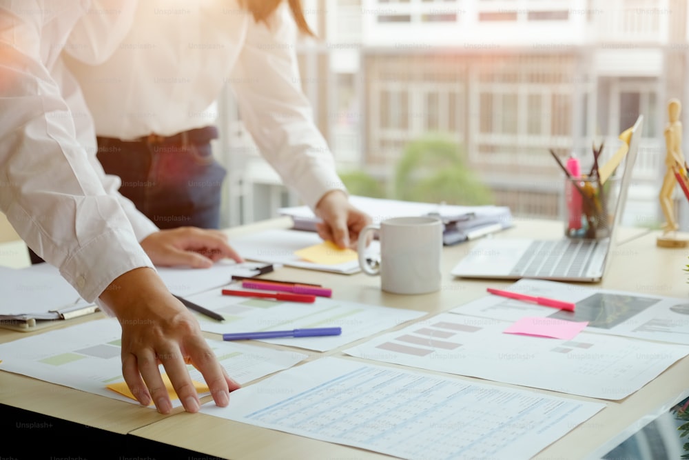 Young business colleagues  talking together while standing at a table in a modern office