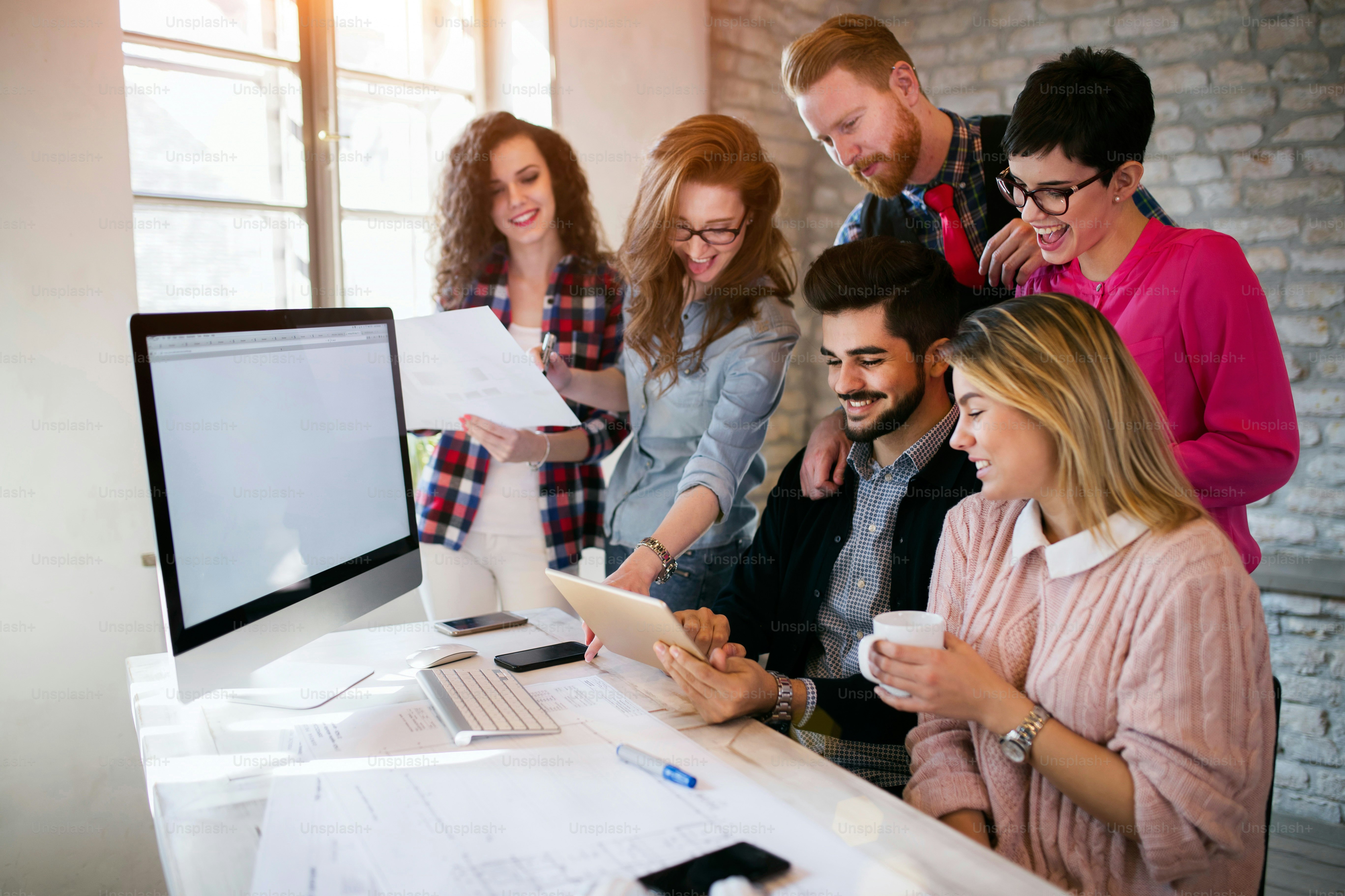 Group of young architects using digital tablet in office