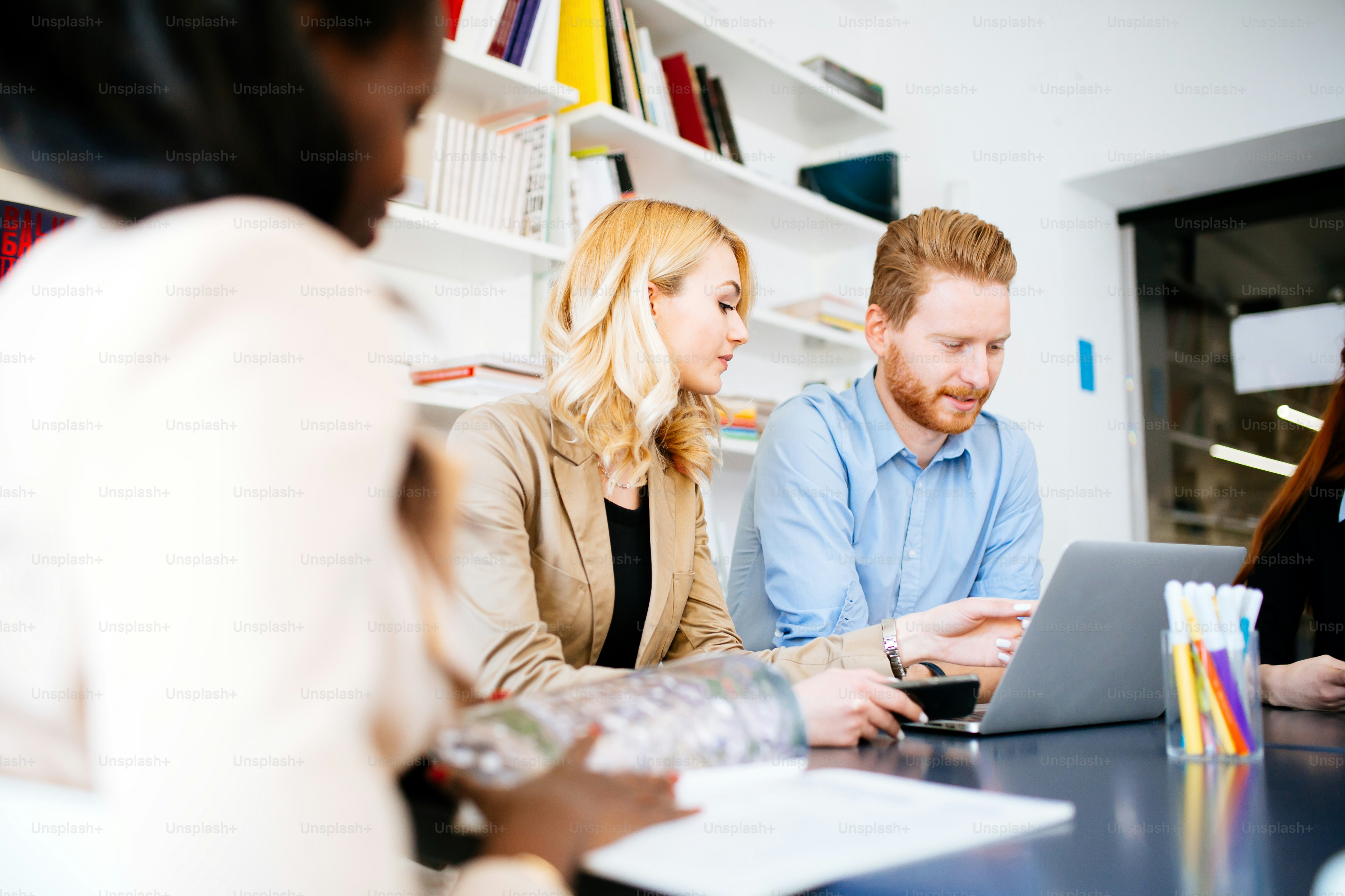 Business people collaborating in office and working on project together ...