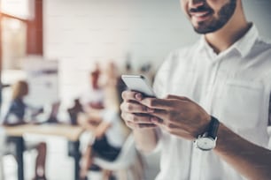 Grupo de jóvenes que trabajan en una oficina de luz moderna en el fondo. Hombre de negocios en el trabajo.