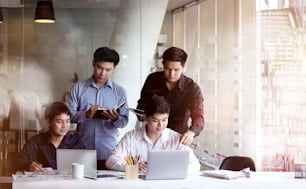 Cropped shot of a group of Asian businesspeople working on a table in the office