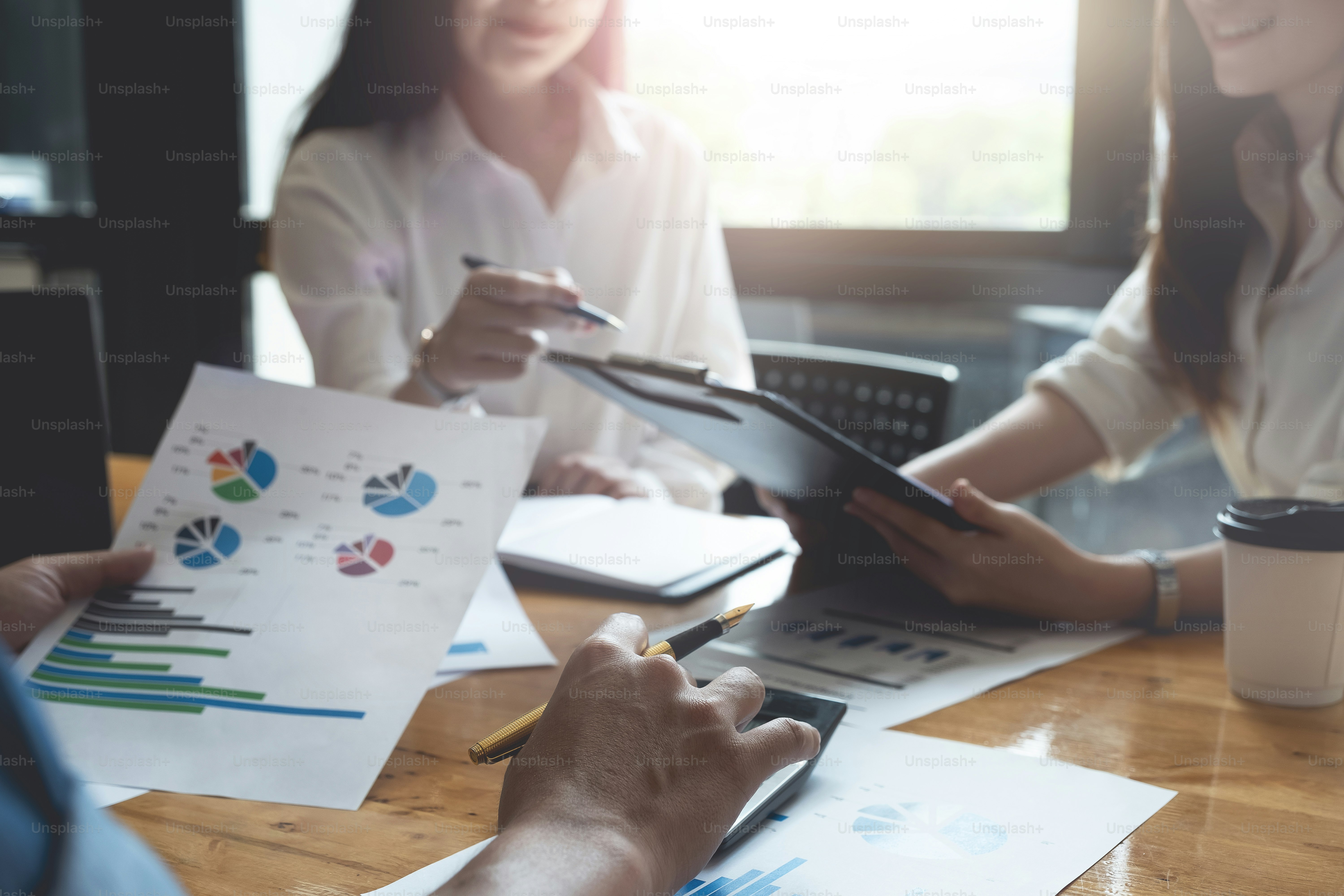 Close up Businessman and partner using calculator and laptop for calaulating finance, tax, accounting, statistics and analytic research concept