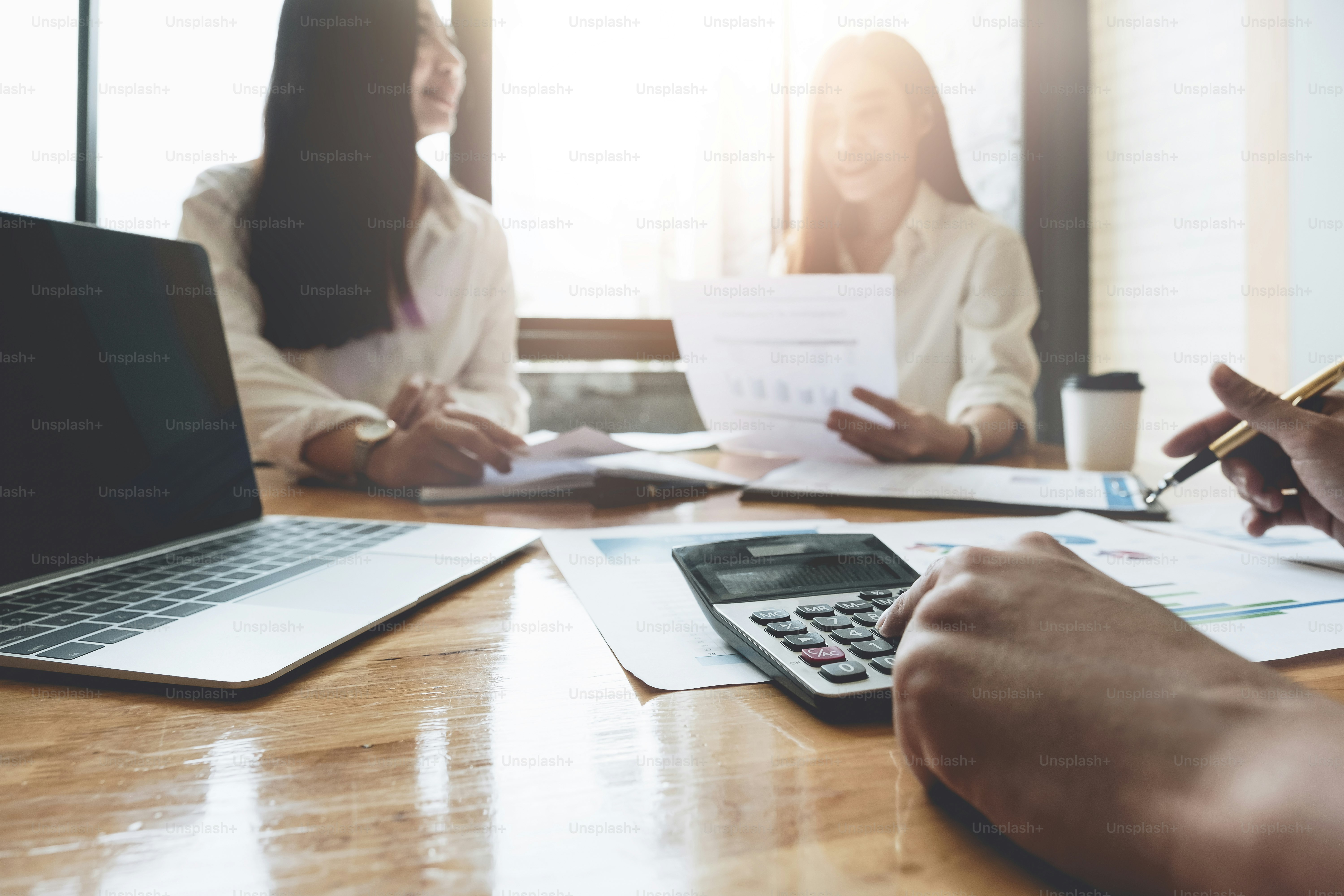 Close up Businessman and partner using calculator and laptop for calculating finance, tax, accounting, statistics and analytic research concept
