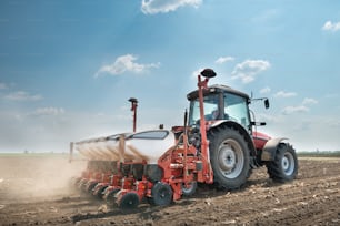 tractor and seeder planting crops on a field
