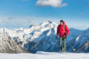 Man walking in a winter landscape whit snowshoes in a high mountain.